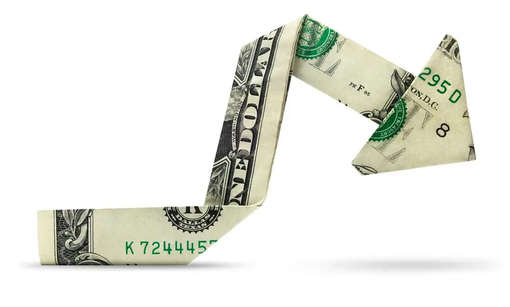 A dollar bill folded into an arrow.