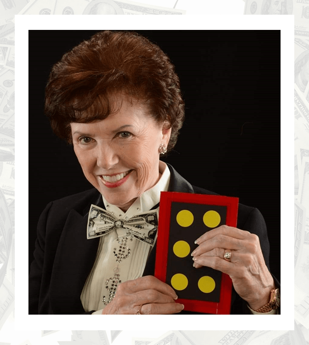 A woman holding a box of yellow buttons.