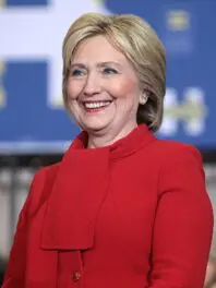 A woman in red jacket smiling for the camera.