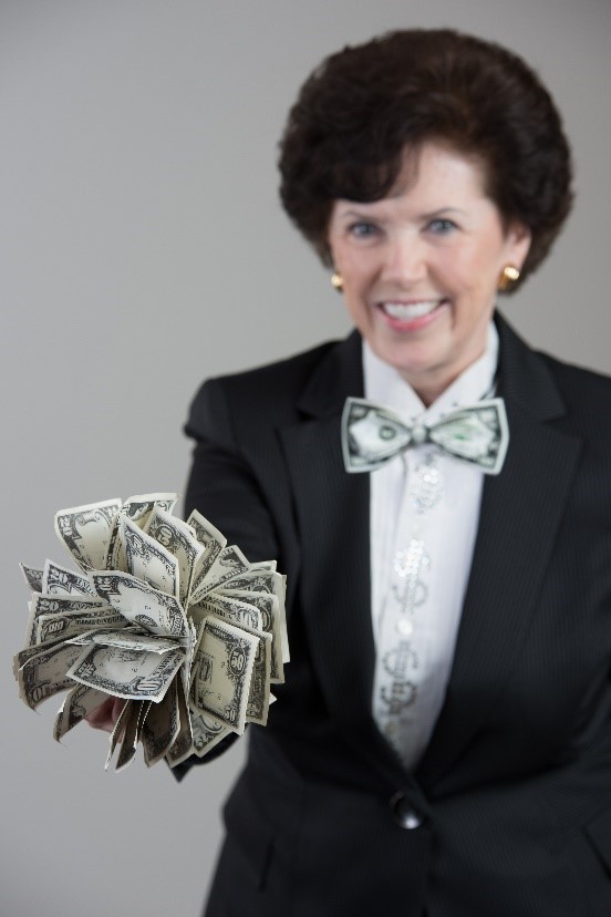 A woman in a suit holding money