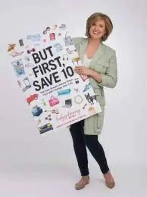 A woman holding up a sign that says " but first, save 1 0 ".