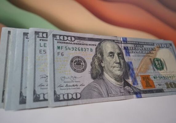 A close up of three hundred dollar bills